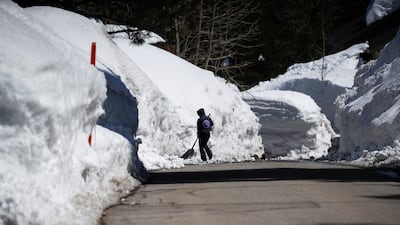 A resident shovels snow after a series of winter storms dumped heavy snowfall. EPA