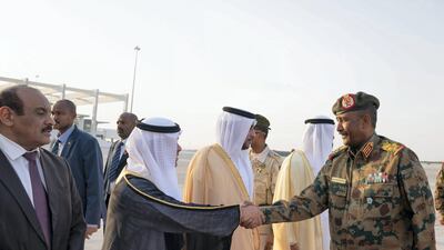 Lieutenant General Abdel Fattah Al Burhan Abdelrahman greets a dignitary, upon his arrival at the Presidential Airport. Mohamed Al Hammadi / Ministry of Presidential Affairs