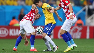 Oscar, centre, of Brazil controls the ball against Luka Modric, left, and Ivan Perisic of Croatia during the 2014 FIFA World Cup Brazil Group A match between Brazil and Croatia at Arena de Sao Paulo on June 12, 2014 in Sao Paulo, Brazil. Warren Little/Getty Images