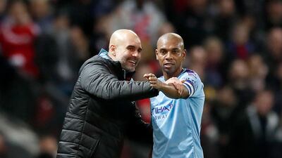 Manchester City manager Pep Guardiola with Fernandinho during the League Cup semi-final first leg at Old Trafford. PA