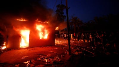 Protesters gather near the burnt Iranian Consulate. Reuters