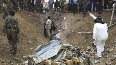 Air force officers and police investigate the site of a military plane crash in Yemen's capital Sanaa today. Khaled Abdullah / Reuters