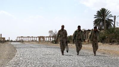 Syrian troops walk in the ancient city of Palmyra after they recaptured the site from ISIL on March 27, 2016. AFP Photo