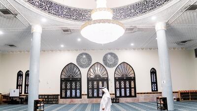 The Imam of Port Saeed Masjid in Al Muraqqabat calls the Maghreb prayer. Reem Mohammed/The National