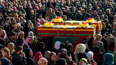 Relatives mourn at a funeral for two Syrian Democratic Forces (SDF) fighters in the Syrian Kurdish-majority city of Qamishli, after they were killed by a Turkish military drone, according to Kurdish security officials. AFP