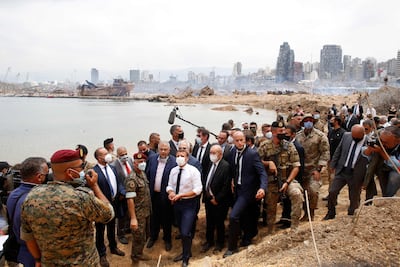 French President Emmanuel Macron and his foreign minister at the time, Jean-Yves Le Drian, visit the port of Beirut, two days after the explosion there in August 2020. AFP