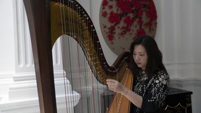 A harpist plays in the lobby at the Raffles Hotel. Bloomberg