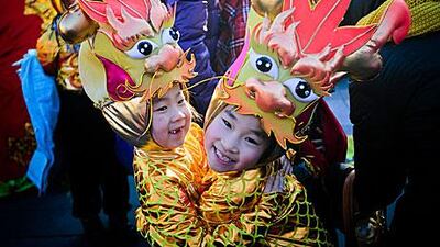 Performers at a Beijing park yesterday, on the eve of the Year of the Dragon. The year usually results in a baby boom.