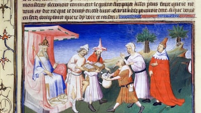 Above, an illuminated manuscript shows Kublai Khan sits on his throne while members of his entourage pay for goods with paper money made from the bark of the mulberry tree. Art Media / Print Collector / Getty Images