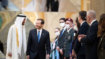 Sheikh Mohamed bin Zayed, Crown Prince of Abu Dhabi and Deputy Supreme Commander of the Armed Forces, left, and Isaac Herzog, President of Israel, greet delegation members at Qasr Al Watan, Abu Dhabi. MOPA