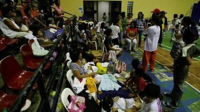 Filipino evacuees gather at a provincial gymnasium following a tsunami alert in Albay province, eastern Philippines.