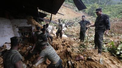 The Sri Lankan army digs through the mud trying to find landslide survivors in Kalupahanawatte, Bulathkohupitiya, about 100km east from Colombo. MA Pushpa Kumara / EPA