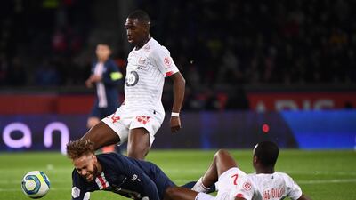Neymar goes to ground after his tussle with Lille defender Tiago Djalo. AFP