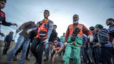Palestinian medics carry a wounded youth during clashes after Friday protests near the border between Israel and Gaza Strip. Mohammed Saber / EPA