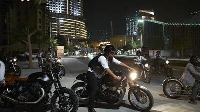A vintage looking Gentlemen pulls into the road on his Triumph to join fellow riders fter a brief stop during the Distinguished Gentleman’s Ride 2014 in Dubai.