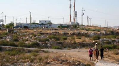 The 'illegal outpost' of Migron in the West Bank, with its mobile homes sheltering under the Israeli army's communication masts.