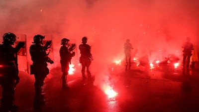 Police officers watch as Red Star supporters throw flares during the Serbian Cup semi-final. AFP