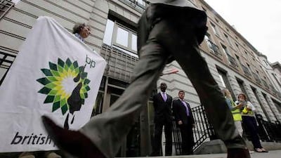 A Greenpeace protester in front of the oil company's headquarters. Also yesterday, BP announced that it had successfully fitted a containment cap on its damaged well in the Gulf of Mexico.
