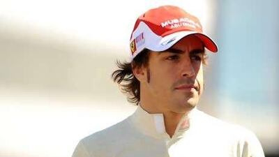 Alonso walks into the paddock at the Silverstone Circuit last week.