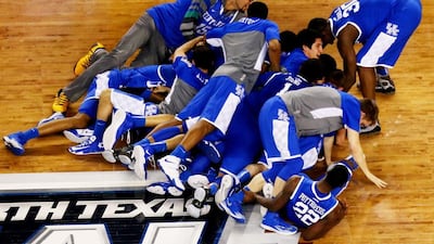 The Kentucky Wildcats celebrate after defeating the Wisconsin Badgers to advance to the NCAA men's basketball national title game on Saturday. Ronald Martinez / Getty Images / AFP / April 5, 2014