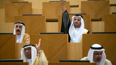 Sultan Al Shamsi, top, strikes a familiar pose during an FNC session. The lawyer from Ajman is not deterred by disapproval of fellow council members and is determined to make points and get answers. Silvia Razgova / The National
