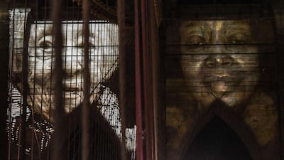 Images of New Yorkers lost in the Covid-19 pandemic are projected on the Brooklyn Bridge on anniversary of lockdown, March 14, 2021. Getty Images/AFP