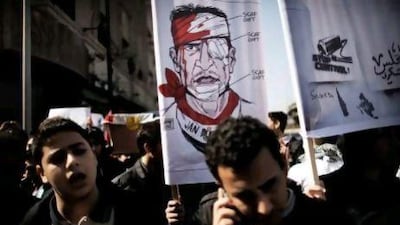 Egyptian students hold a banner portraying a wounded revolutionary as they protest in Cairo on Saturday against the military rulers of the country.