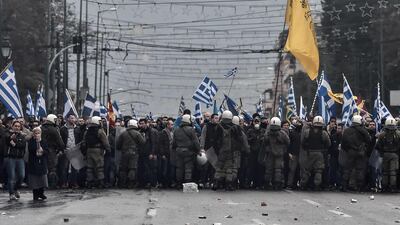 Protesters are blocked by riot police in Athens. AFP