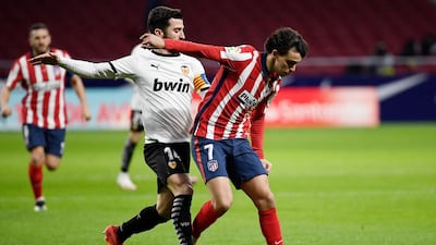 Atletico Madrid's Joao Felix vies with Valencia's Jose Luis Gaya Pena. AFP