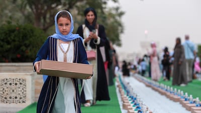 Jusoor volunteers distribute iftar meals at the Sheikh Zayed Grand Mosque in Abu Dhabi. Victor Besa / The National