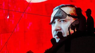 People wave Turkish flags in front of an electronic billboard displaying the face of President Recep Tayyip Erdogan at a rally on the streets of Kizilay Square in reaction to the failed military coup in Ankara, Turkey. Chris McGrath / Getty Images