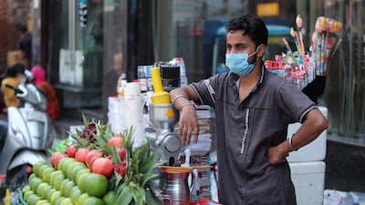 A vendor waits for customers at a market in Jammu, India. AP Photo