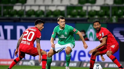 Bremen's German midfielder Maximilian Eggestein (C), Leverkusen's Chilean midfielder Charles Mariano Aranguiz (L) and Leverkusen's German midfielder Karim Bellarabi vie for the ball during the German first division Bundesliga football match Werder Bremen v Bayer 04 Leverkusen. AFP