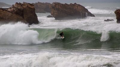 A surfer rides a wave during a heavy swell at Biarritz in south-west France, on Tuesday, October 27. AFP