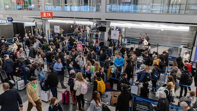 Travellers wait at a security checkpoint in Terminal 3 at O'Hare International airport on November 30 in Chicago, Illinois. Getty Images via AFP