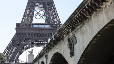 The Olympic rings symbol adorns the Eiffel Tower 50 days before the Games kick off in Paris. EPA