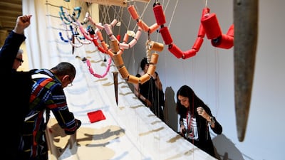 Visitor interact with the artwork 'A Stitch in Time' by Medalla during the 57th International Art Exhibition Biennale in Venice, May 2017. AFP