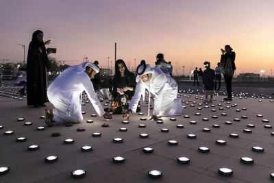 Volunteers help set up the light installation which celebrates a five-month journey spanning five continents for the Zayed Sustainability Prize's Guiding Light scheme. Reem Mohammed/The National