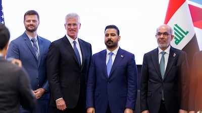 Mark Nelson, second left, vice chairman of Chevron, and Ali Al Zaidi, second right, Iraq's Prime Minister, after a meeting in Houston, Texas. Chevron is among the US oil firms to have signed deals with Iraq. Bloomberg