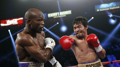 Manny Pacquiao, right, of the Philippines, throws a right at Timothy Bradley during their WBO welterweight boxing bout Saturday, April 9, 2016, in Las Vegas. (AP Photo/John Locher)