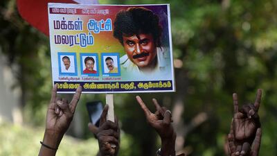 Indian fans of Rajinikanth celebrate after his announcement that he will enter into politics, in Chennai. Arun Sankar / AFP