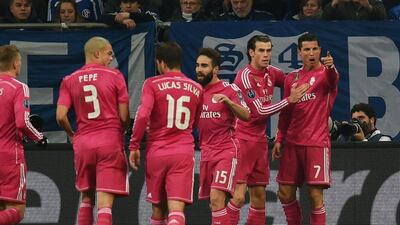Cristiano Ronaldo, right, celebrates with teammates after putting Real Madrid ahead in their Uefa Champions League first leg tie at Schalke. Patrick Stollarz / AFP