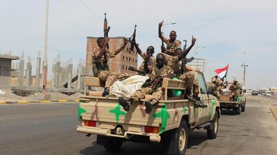 Sudanese soldiers wave after their arrival in Aden on November 9, 2015, to take part in coalition operations in Yemen. Wael Qubady / AP Photo