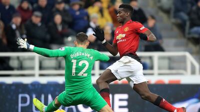 Manchester United's Paul Pogba, right, dribbles past Newcastle United goalkeeper Martin Dubravka but misses an open goal PA via AP