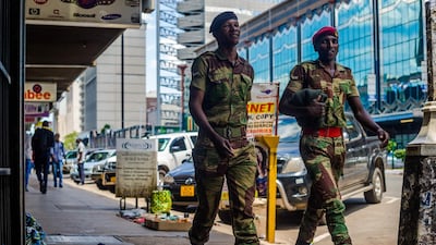 Zimbabwean soldiers walk through the Central Business District in the capital Harare on November 20, 2017 as a political crisis entered its second week with president Robert Mugabe resisting his party's call to step down. Jekesai Njikizana / AFP