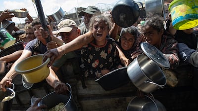 Internally displaced Palestinians receive food donated by a charity in Khan Younis camp, southern Gaza on September 6. The UN’s World Food Programme says no food has entered northern Gaza since October 1. EPA