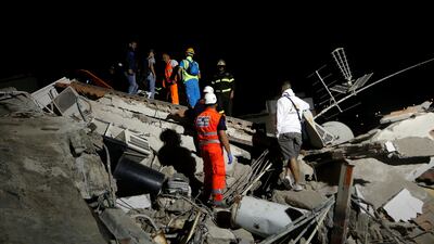 Rescue workers check a collapsed house after an earthquake hits the island of Ischia. Ciro De Luca / Reuters