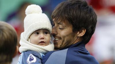 Manchester City’s David Silva with his child before the match. Darren Staples / Reuters