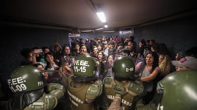 Chilean Police close the access to the Los Heroes metro station in the middle of a demonstration, in Santiago, Chile. EPA
