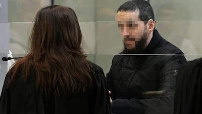 Mohamed Abrini talks with his lawyer in court during the trial of the 2016 Brussels attacks, at the Justitia building in Brussels. Reuters